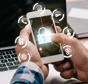 Person holding smartphone with glowing lock icon and cybersecurity symbols representing SQL Server Change Data Capture security, data encryption, access control and real-time data protection